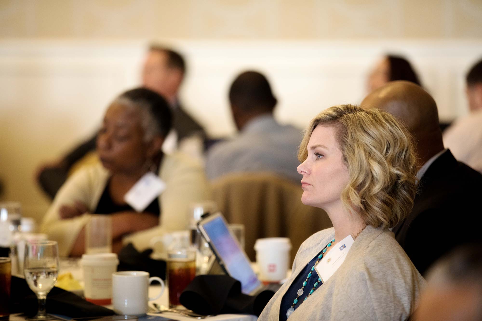 Woman watching speakers at conference